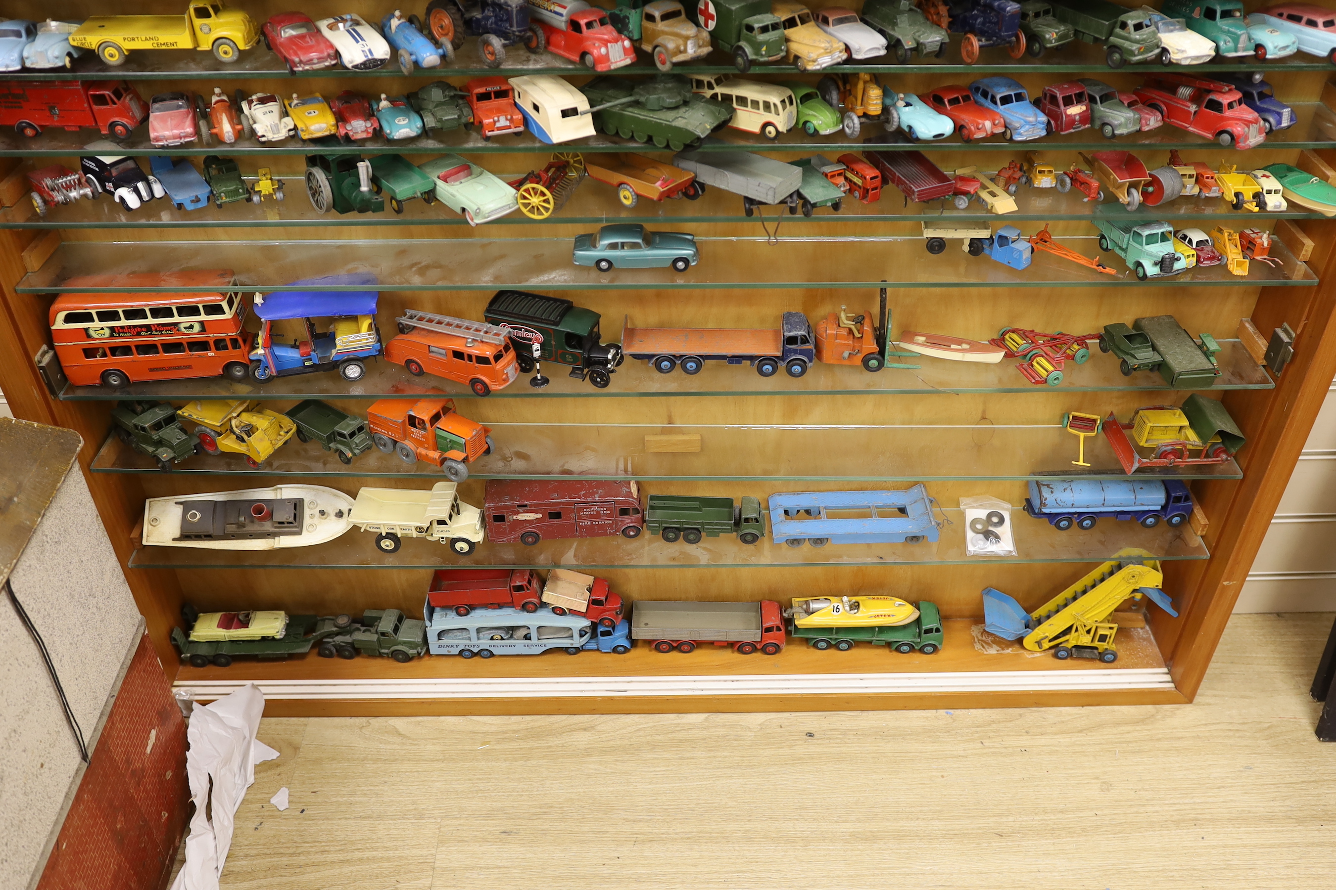 A collection of diecast vehicles in display case